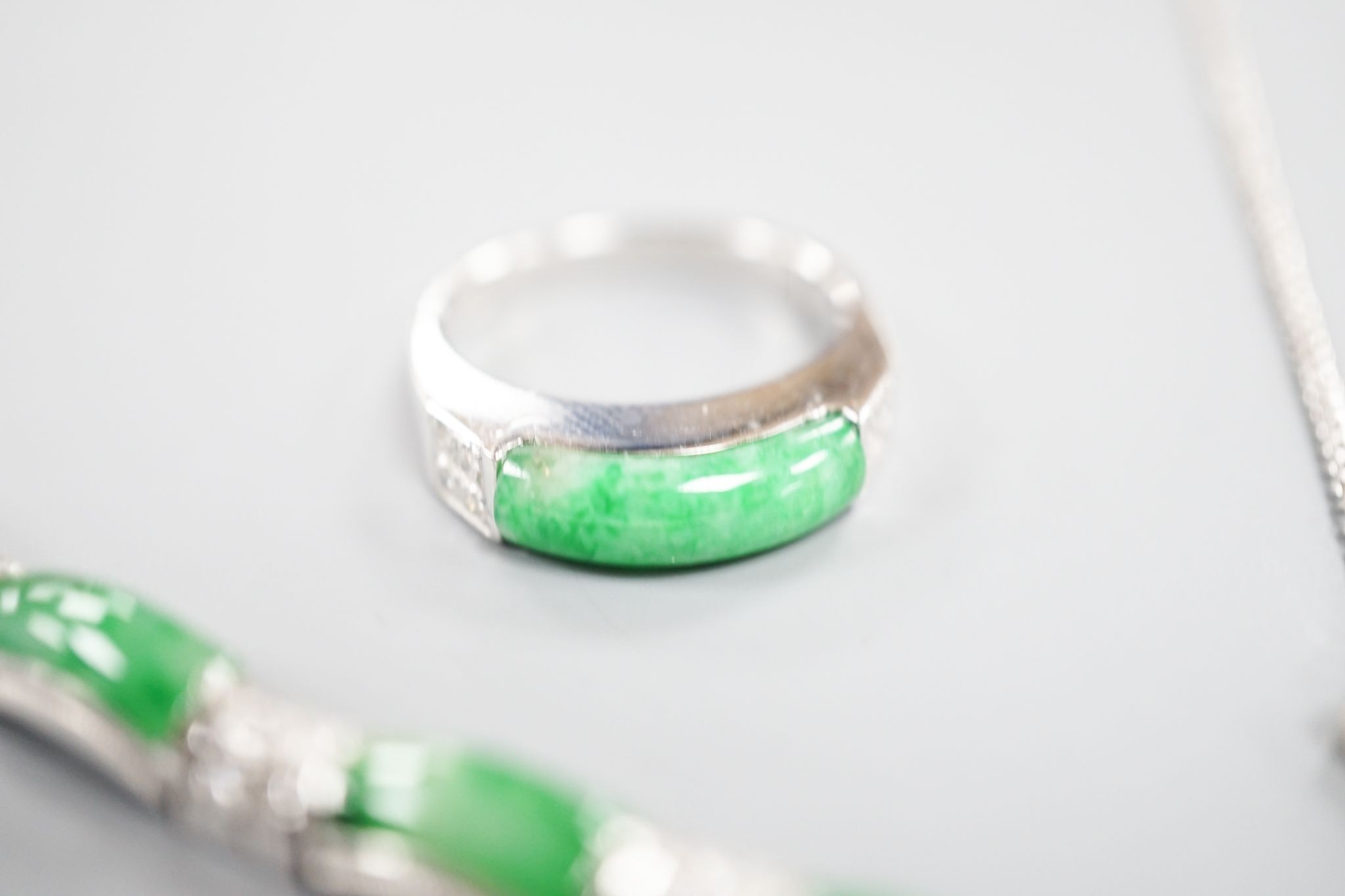 A modern white metal (stamped 850), jade and diamond cluster set bracelet, approx. 15.5cm, with a matching ring, size O and necklace, 38cm